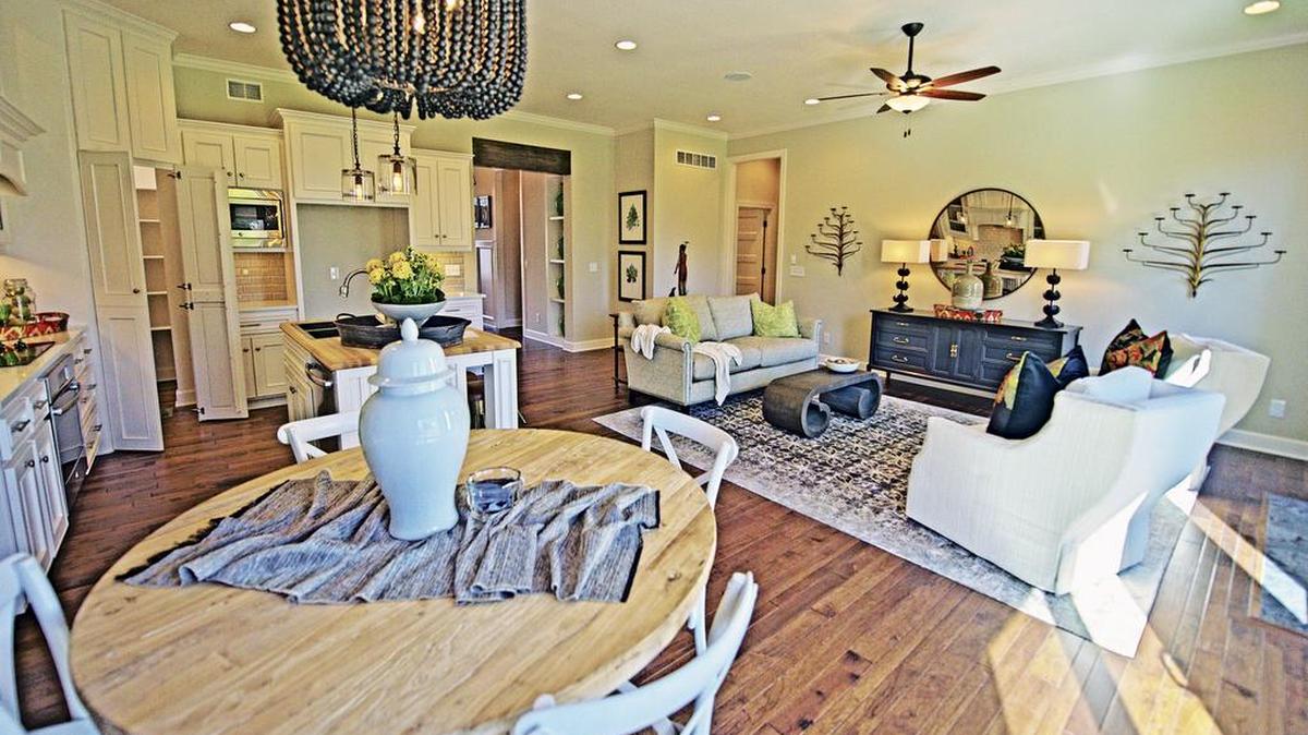 The kitchen and living room of Gabriel Homes’ Richmond plan in Grayson Place are open and ideal for entertaining. The villa is loaded with custom cabinets, beautiful hardwood floors and superb tile, and the latest in energy-efficient amenities.