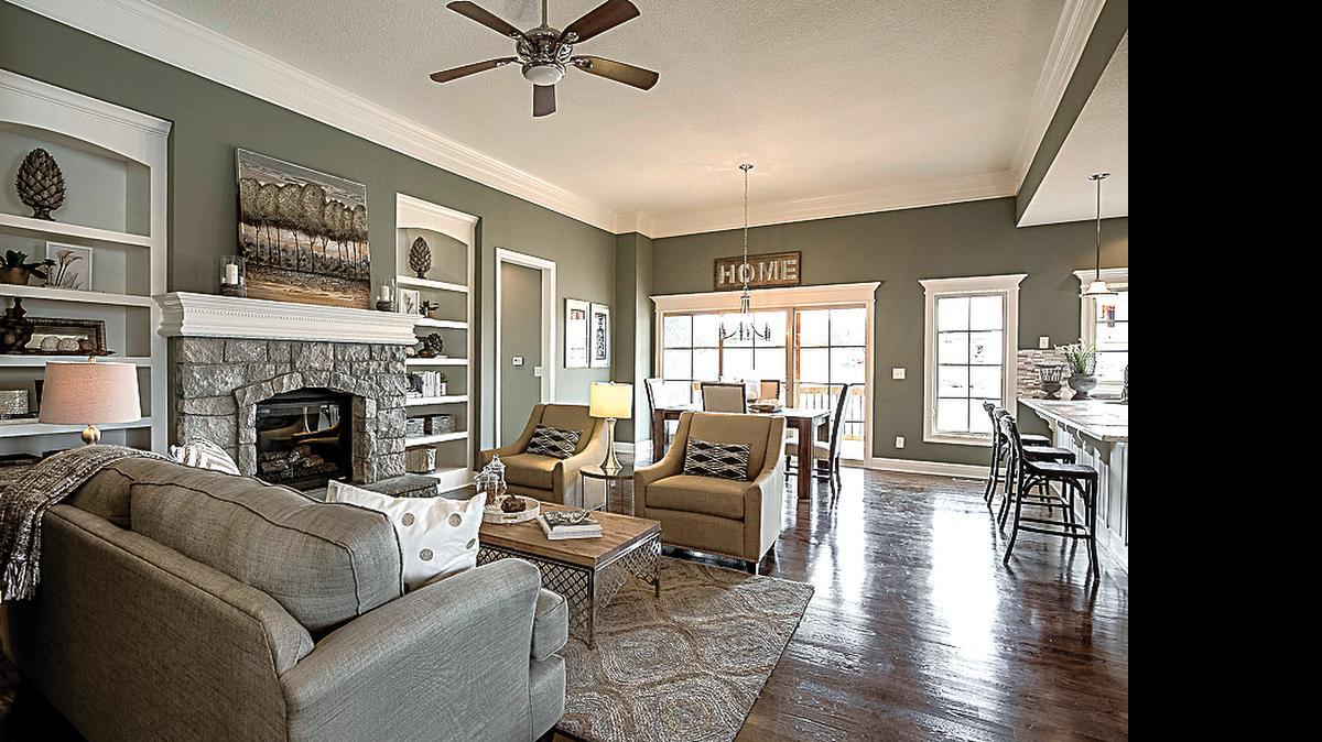 
This Thom II floor plan boasts an abundance of natural light, hardwood floors, stone fireplace with custom mantel, built-in shelves, 11-foot high ceilings in the great room and a glass door that leads to the covered deck.
