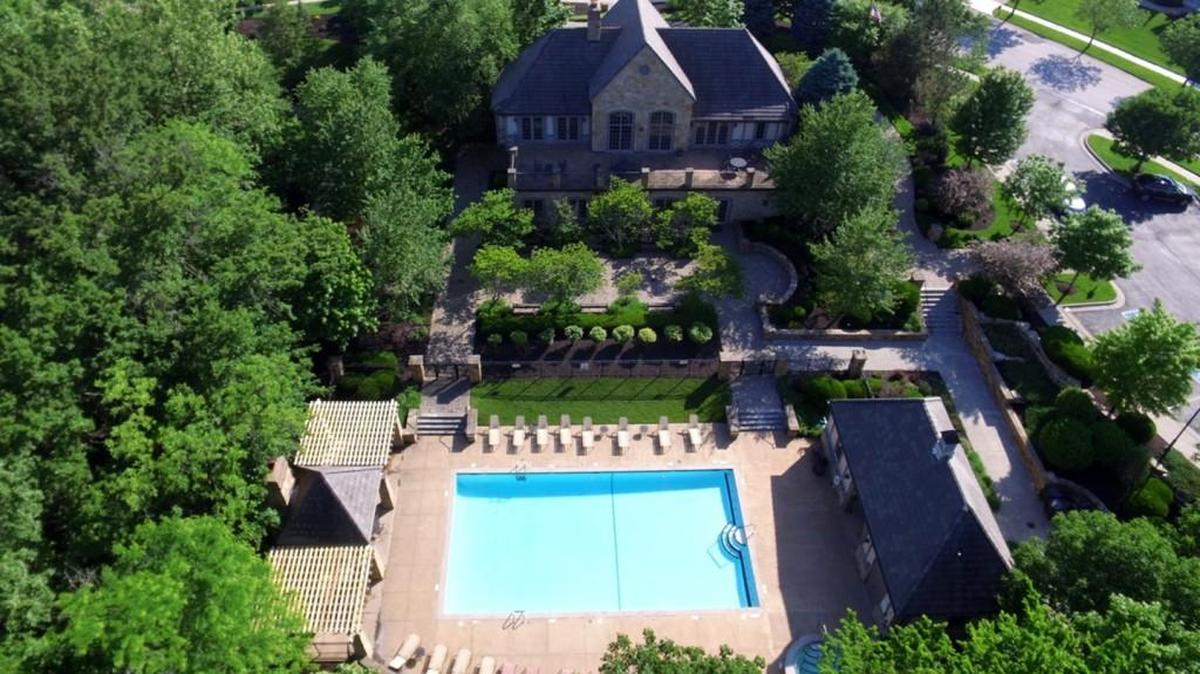The Gate House at Shoal Creek Valley features plush grounds, meandering garden pathways, media and banquet rooms, a fully equipped kitchen, patios, a large swimming pool, waterfall, hot tub and barbecue pavilion.