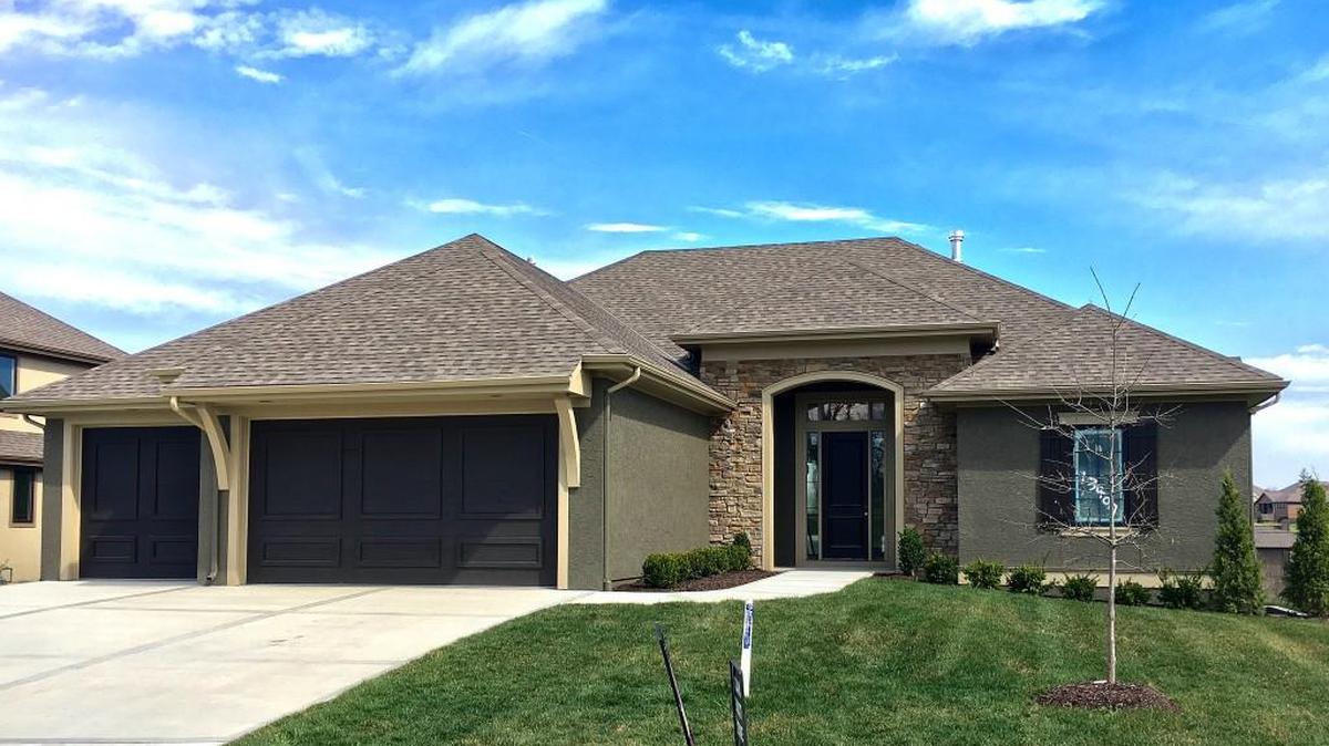 The Vail Valley reverse 1½-story by Dan Smith Homes is located at 13407 W. 169th Terrace and features a walkout basement and a covered deck. Priced at $529,950, the home is on a cul-de-sac lot that backs to green space and includes a 30-day close.