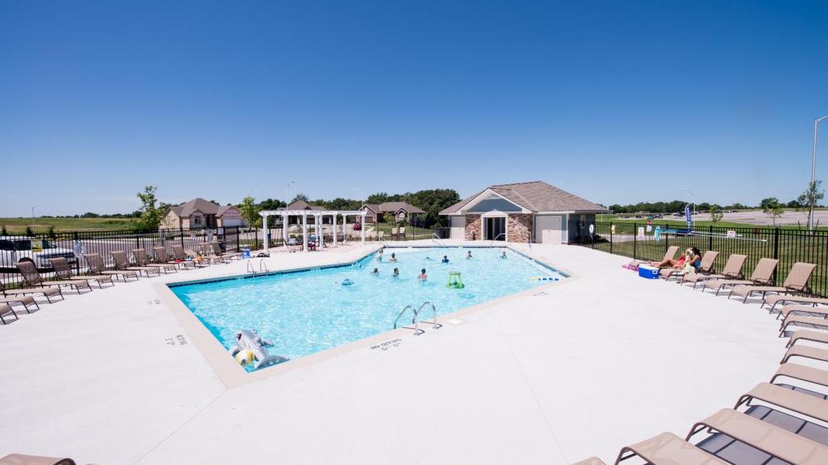 Residents enjoy the neighborhood swimming pool and bath house at The Reserve at Riverstone.
