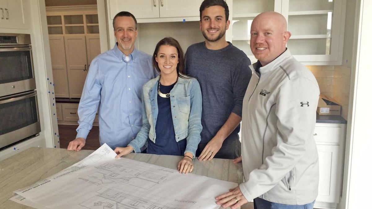 Tanner Tolbert and Jade Roper, who famously met on the reality show “The Bachelor,” just put a hold on a lot in Rodrock Development’s Southwick on the Lake. From left in the photo are Tom Langhofer, General Manager for Rodrock; Jade Roper, Tanner Tolbert and builder Todd Hill of Todd Hill Homes.