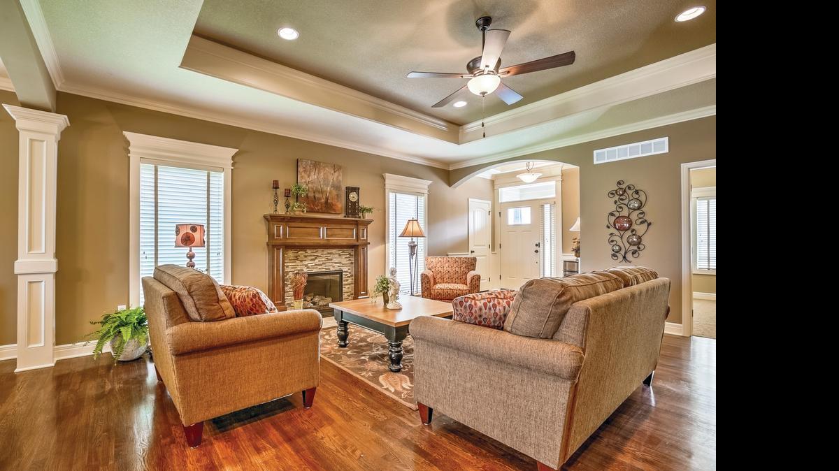 
The Richland ranch plan in the Cottages of Cross Point Creek boasts an open living area with many custom details. The wainscoted entry flows into a great room with a high ceiling and stately, stained mantel accented with glass and granite mosaic tile. 
