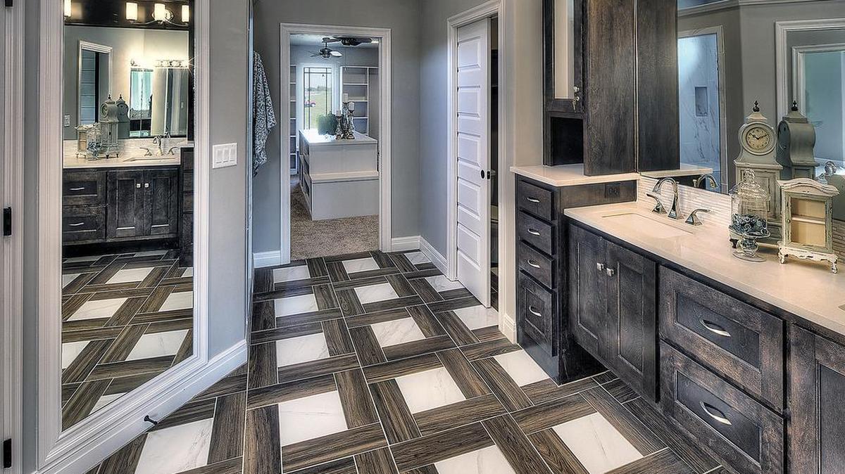 Mixed materials make up this beautiful master bathroom floor from Dreams & Design Building, Tour #225.