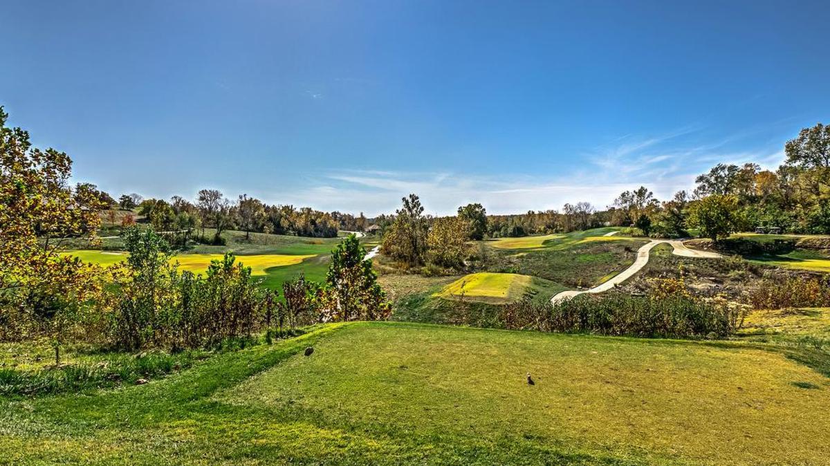 The picturesque view from lot 65 at Cottonwood Canyon includes the lush landscaping of Canyon Farms Golf Club. The homesite is currently available for prospective buyers interested in a prime location for a custom-built home.