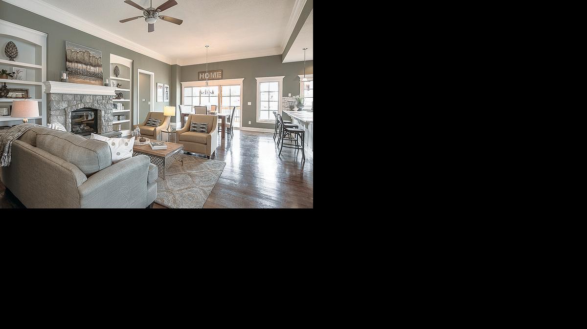 
This Thom ll floor plan boasts an abundance of natural light, hardwood floors, stone fireplace with custom mantel, built in shelves, 11-foot high ceiling in great room and glass door that leads to the covered deck.
