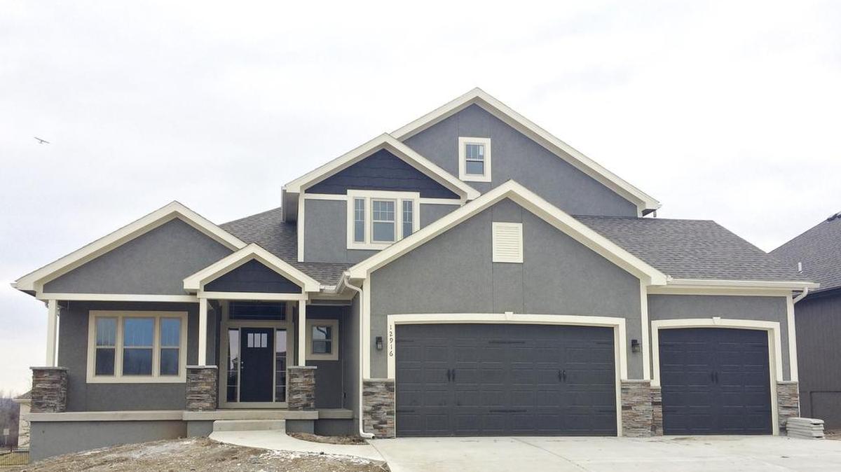The Anderson 1½-story at 12916 W. 169th St., by Nick Zvacek Construction features a walkout finished basement including a home theater system with flat screen TV, five bedrooms, 4½ bathrooms, a covered deck and front porch elevation. The home is priced at $468,000 and includes 30-day delivery.