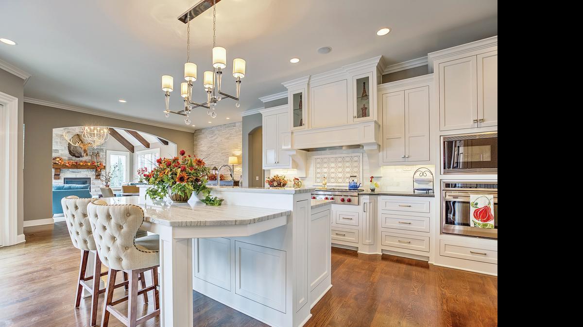 
This spectacular kitchen, outfitted with commercial appliances and a stunning marble island to accommodate meal prep, dining and entertaining, is the result of collaboration between the homeowner, Rodrock Homes Custom Division, architects and interior designers. 
