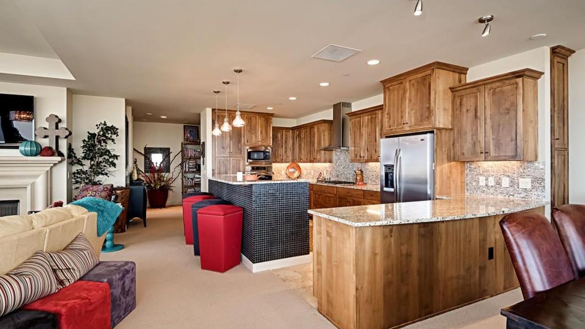 Design and lighting upgrades, including a kitchen island wrapped in mosaic glass tile, are found throughout a 2,900-square-foot, two-bedroom home on the seventh floor.