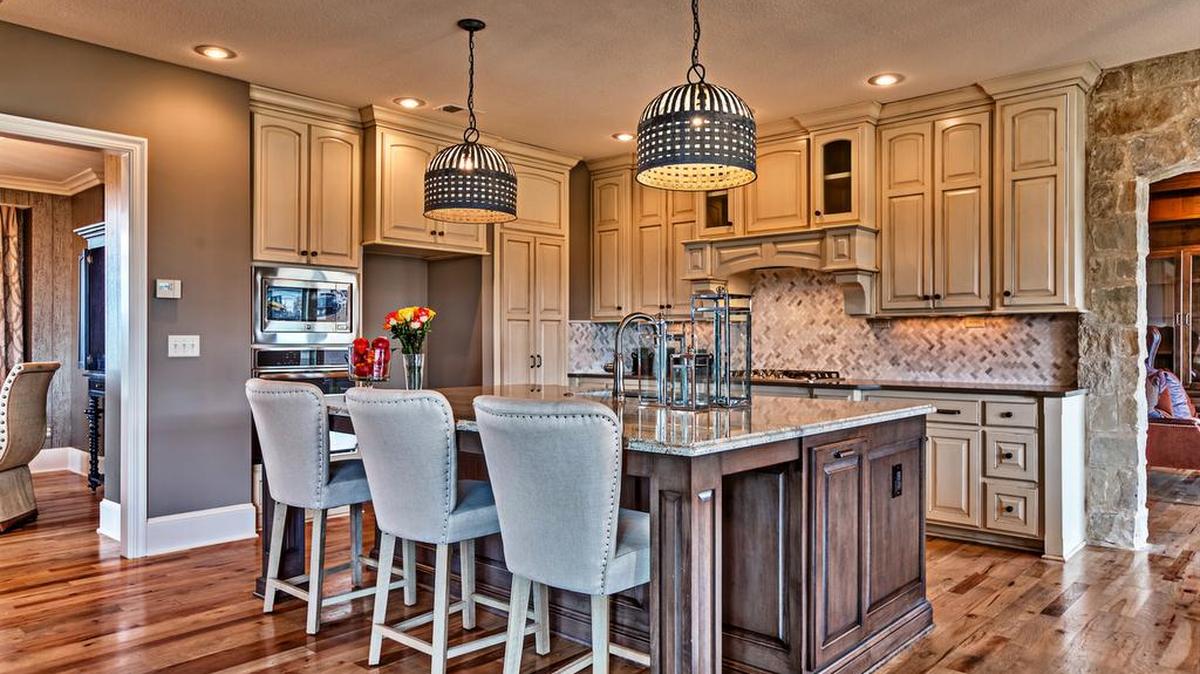 The Larsen EX floor plan is warm and inviting and boasts an open floor plan, including a well-equipped L-shaped gourmet kitchen with a substantial island, ample counter space and a walk-in pantry.