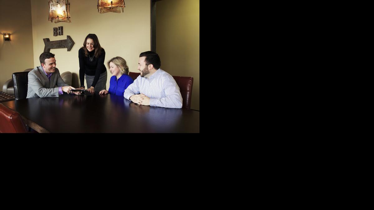 
Jodi Schade, vice president of Media, Marketing and Technology for Berkshire Hathaway HomesServices Kansas City (standing) reviews the new 2015 marketing tools with Matt Toepfer, from left, Rebekah Groebe and Andy Blake, three of the company’s top sales associates.
