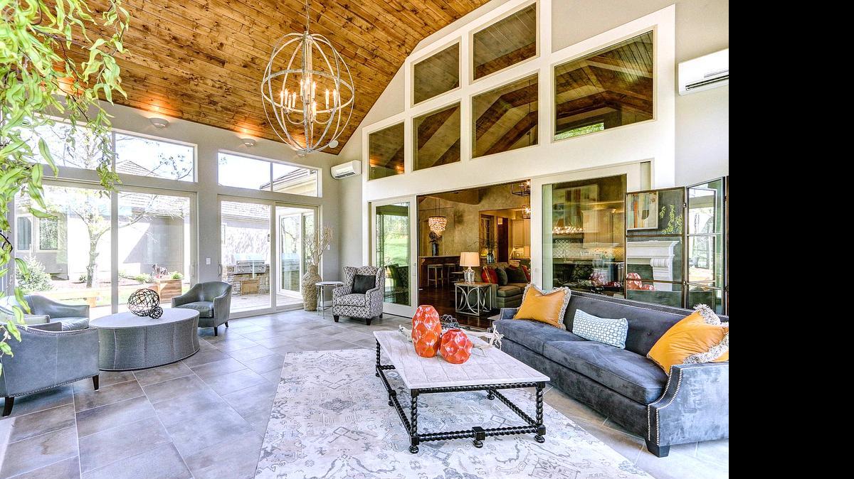 
This four season room in the Don Julian Builders’ home at the Village of Loch Lloyd has glass walls that open during the spring and fall and close to shut out summer heat or winter cold.
