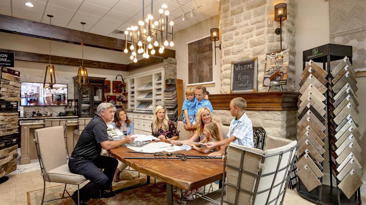 CEO Brian Rodrock and interior designer Kristen Ridler meet with a family to finalize interior selections at the Rodrock Design Center.