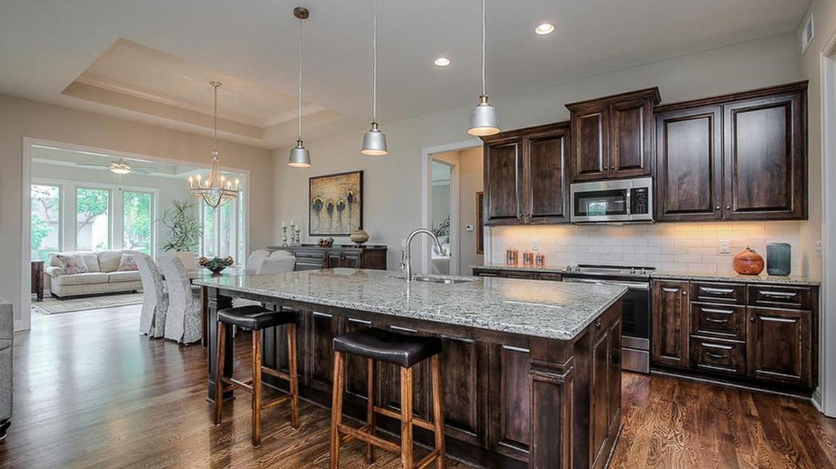 All three models at Solera Reserve, 139th and Quivira in Overland Park, have open designs that include the living room, dining area and kitchen. The kitchens feature large islands, granite countertops, maple custom cabinets and melamine interiors, which are standard.