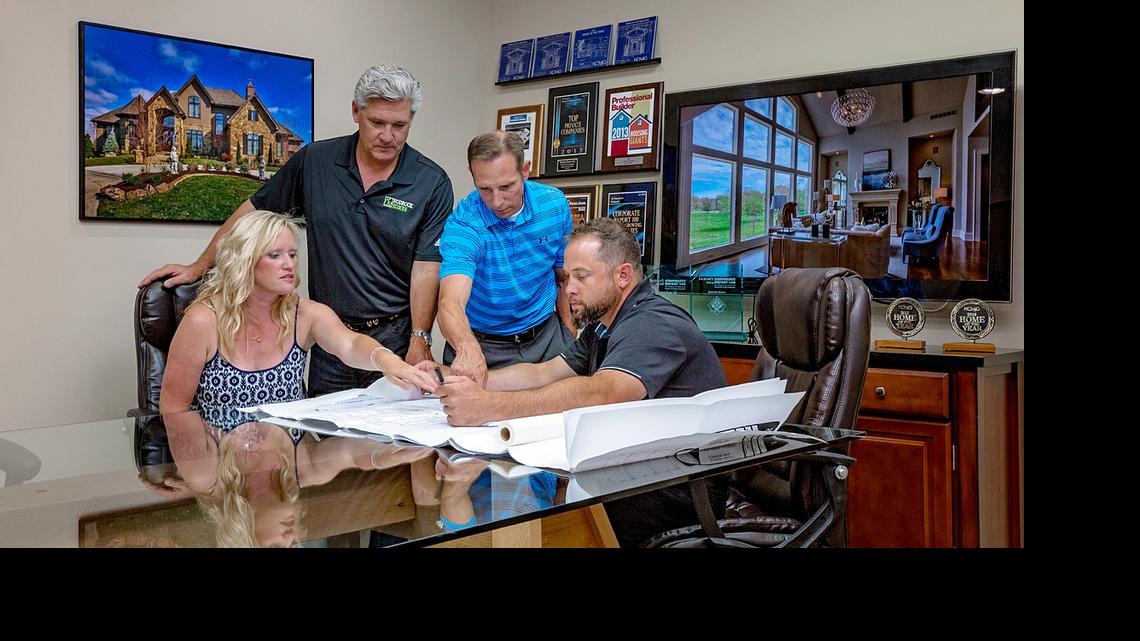 
Brooke and Brian Rose, scheduled to move into their custom-built Wyngate home in July, meet with Rodrock Homes chief executive officer Brian Rodrock (second from left) and chief operating officer Jeff Gifford (seated).
