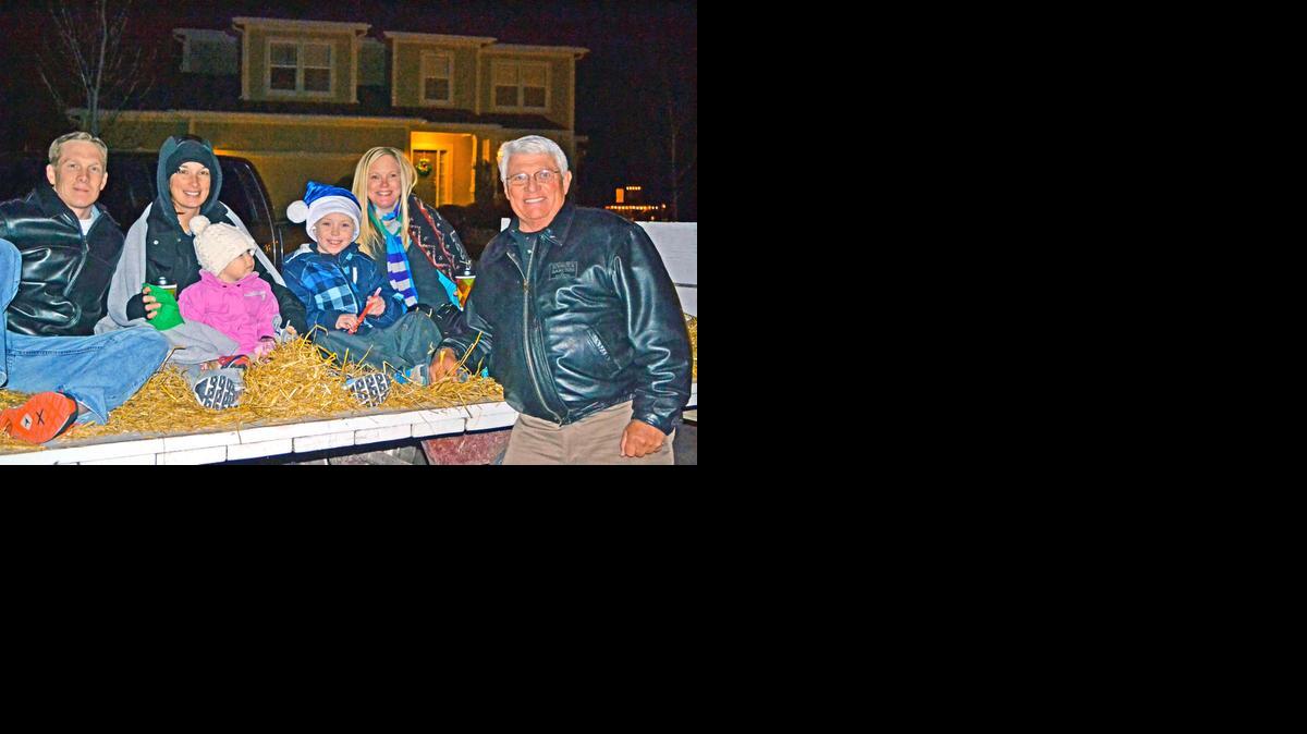 
Darol Rodrock, far right, visits with families during the Holiday Hayride in Stonebridge Meadows.

