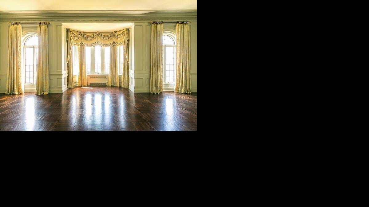 
The living room of the luxury penthouse in The Walnuts features leaded glass windows with silk brocade dressings. Cates Auction will sell the 9,000-square-foot home on Jan. 30.
