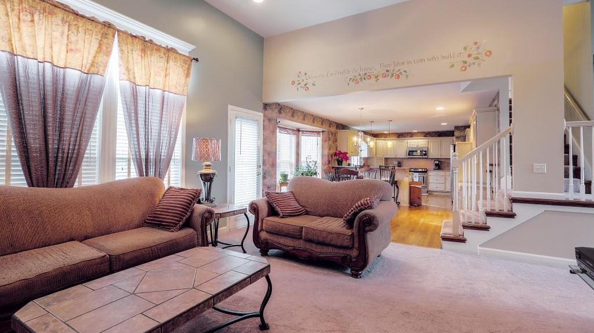 This charming 3,900 square foot, two-story, five-bedroom, 3-1/2-bathroom home at 1415 80th St. in Kansas City in the Southridge neighborhood features this spacious living room area with lots of natural light.