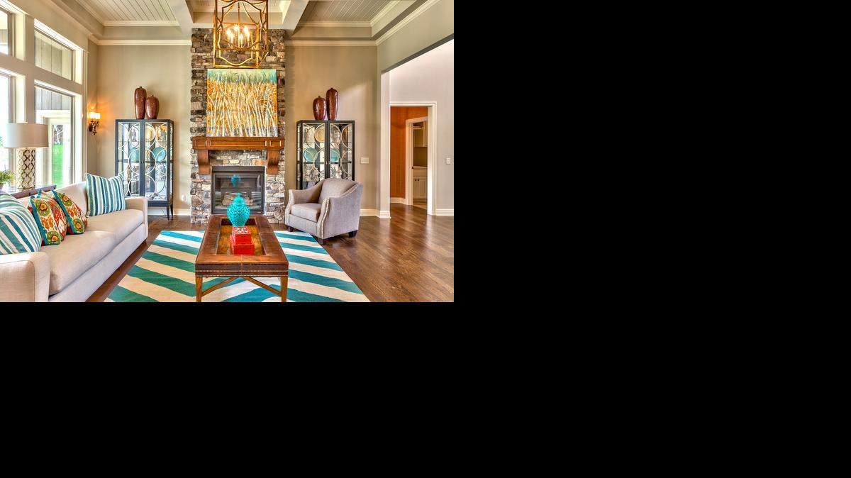 
A box-beam tongue-and-groove ceiling, dramatic floor-to-ceiling stone fireplace and large windows overlooking the covered deck accent the El Dorado’s great room.
