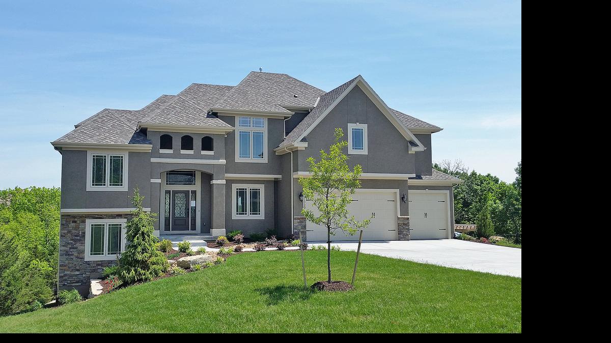 
KC Building Co. offers this home, priced at $629,950, with his-and-hers offices, an oversized kitchen hearth room with fireplace, box-beam ceiling, island and walk-in pantry, a luxurious master suite with a sitting alcove, fireplace and martini deck and several kids’ rooms and closets. 
