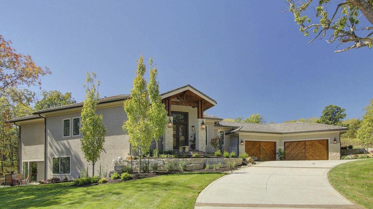 This home, built by Willis Custom Homes and designed by renowned architect Scott Bickford, sits high on a hill at 100 Dunhill Court, offering sweeping views of Loch Lloyd.