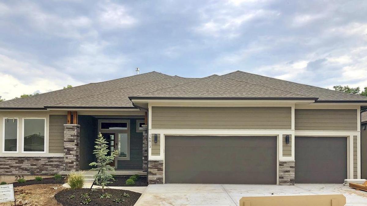 The award-winning Emery reverse 1½-story by James Engle Custom Homes at 16813 Bradshaw is nearing completion with a new mid-century front elevation; a walkout/walkup basement; and a covered deck. The home is priced at $514,125 and 30-day delivery is possible.