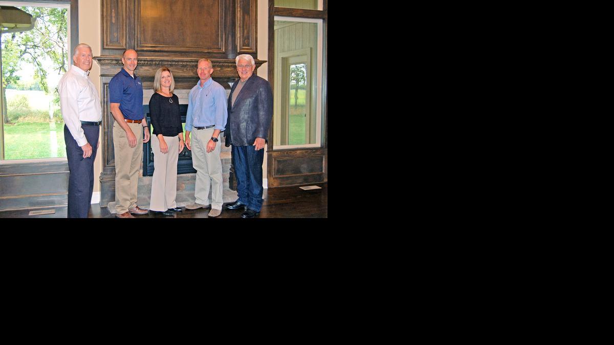 
From left, Ed Stephenson with Rodrock & Associates; Ben Tarwarter, Kim Brune and Jim Engle, all with James Engle Custom Homes; and Darol Rodrock, owner of Rodrock Development, tour the charity home built by James Engle Custom Homes. 
