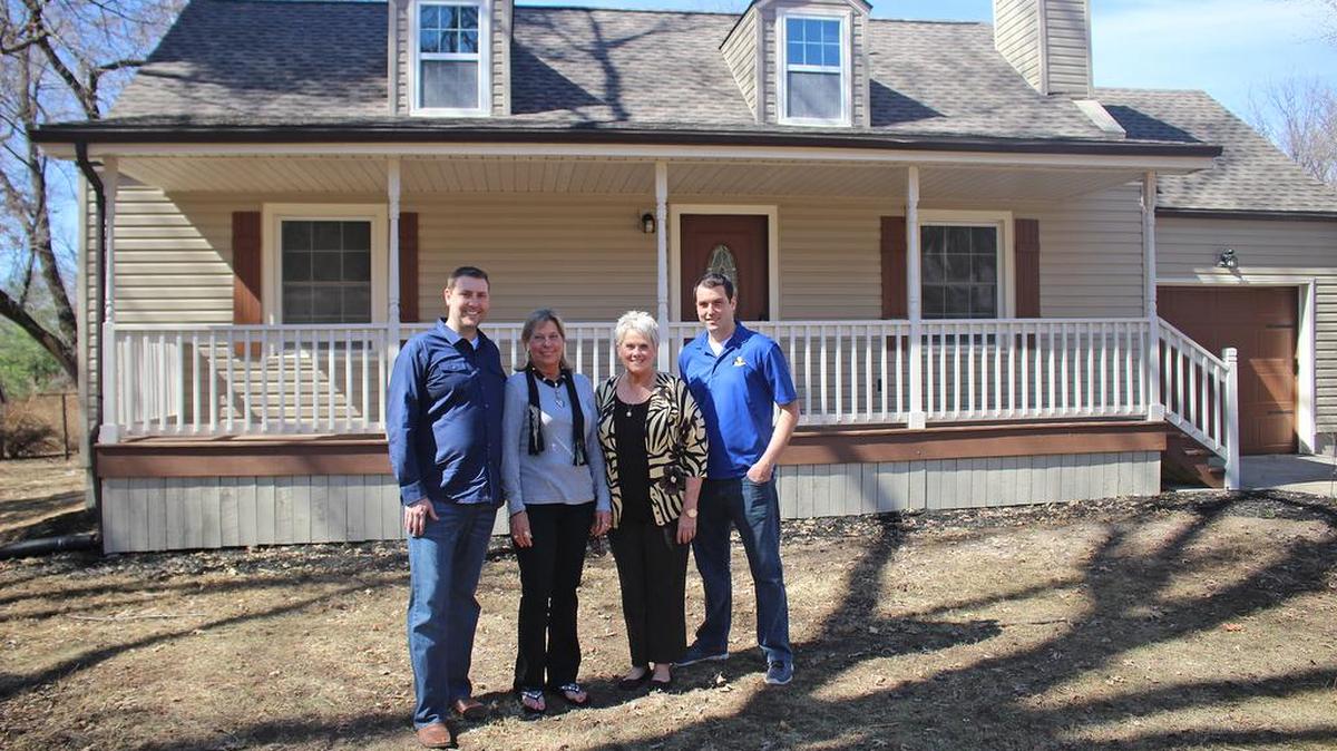 
Brandon Logan, left, and Brett Shelton, owners of KCCashHomebuyers.com, bought this home inherited by Mary Arbuckle, second from left, and Cheryl Pierce, then renovated it to resell.

