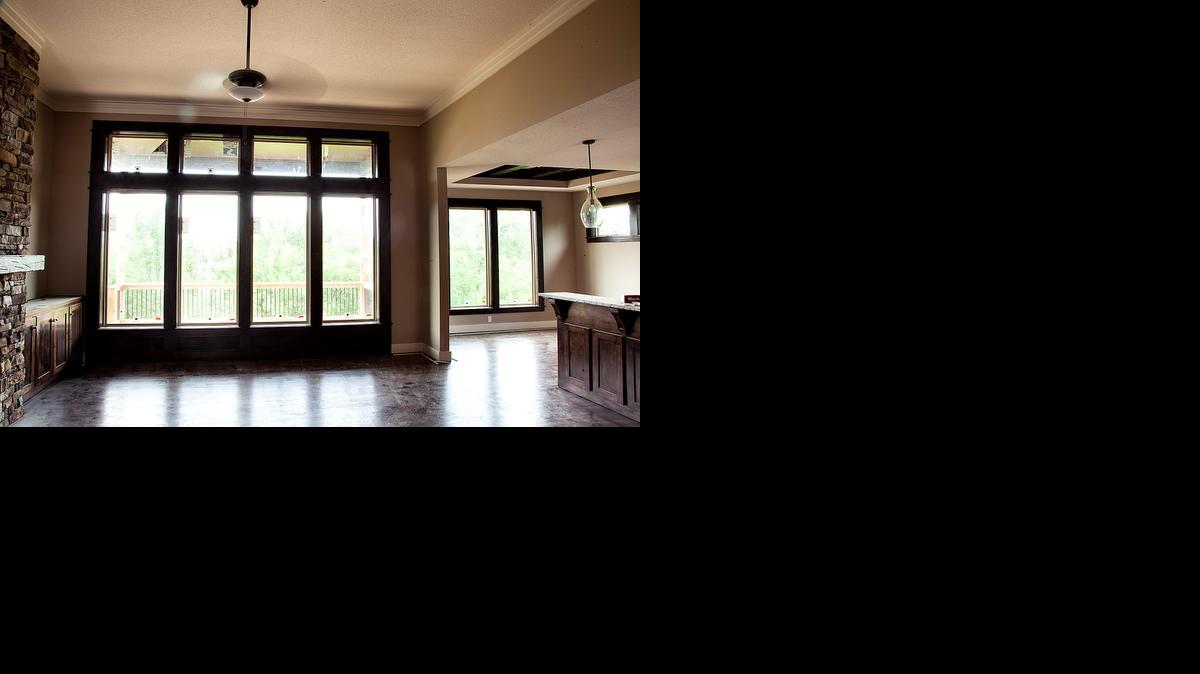 
The large windows of this nearly completed Heatherglen home allow light to flood the great home, which also features a stacked-stone fireplace. 
