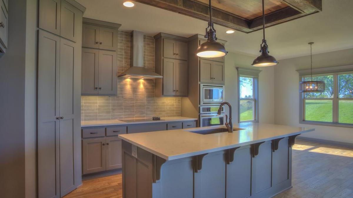 The Brookline is a spacious 1.5 story by SAB Construction; the contemporary farmhouse kitchen enhances this open plan. The master on the main and three bedrooms plus a loft upstairs make this the perfect family home.