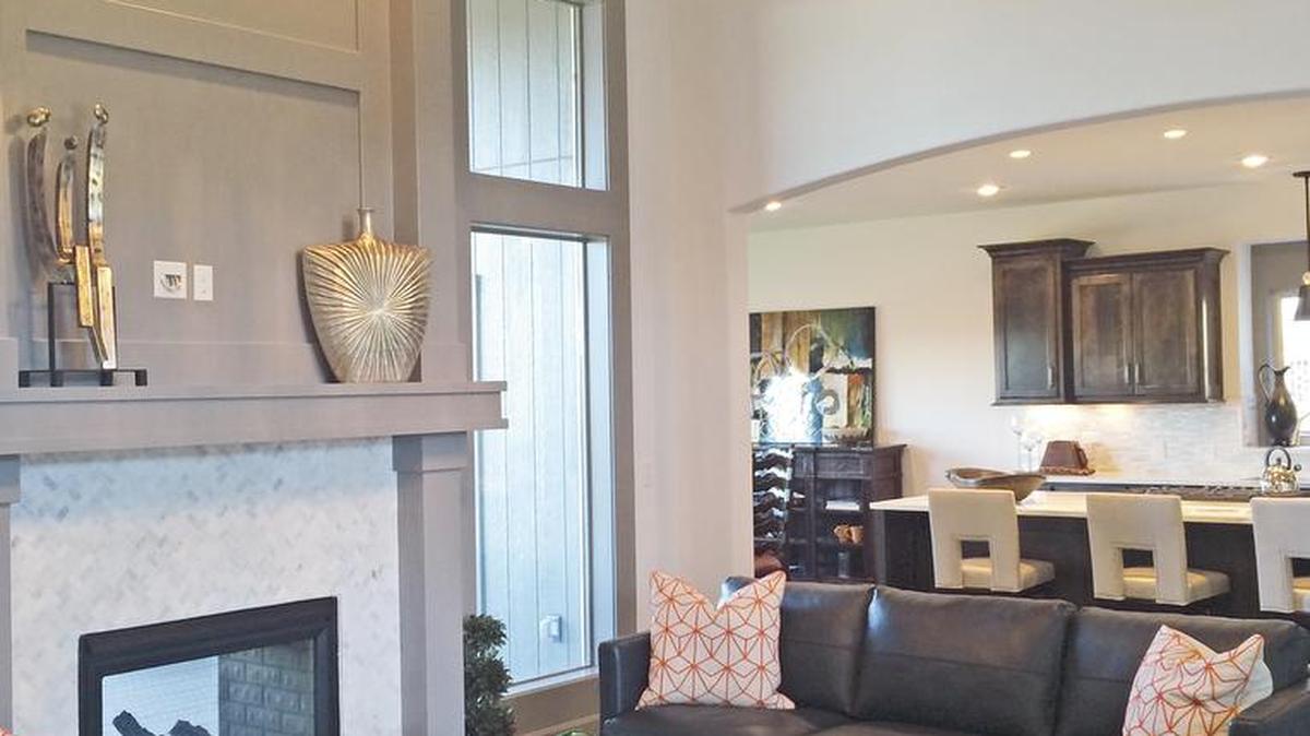 High ceilings are featured with designer wall and trim colors in this Don Julian Builders reverse 1 ½-story Wyndham plan with a four-car garage. Located at 13016 W. 170th Street, the home is priced at $519,900 and includes 30-day delivery.