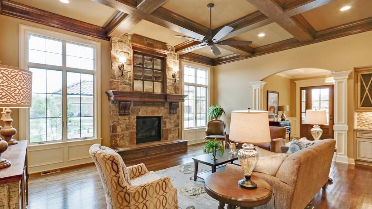 This stunning great room at Tuscany Piazza Townhomes offers views of the community pond and fountain.