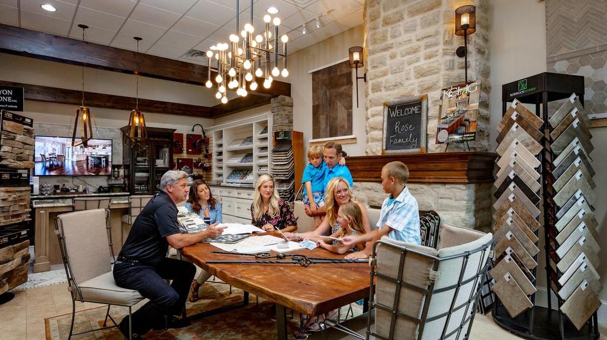 CEO Brian Rodrock and interior designer Kristen Ridler meet with a family to finalize interior selections at the Rodrock Design Center.