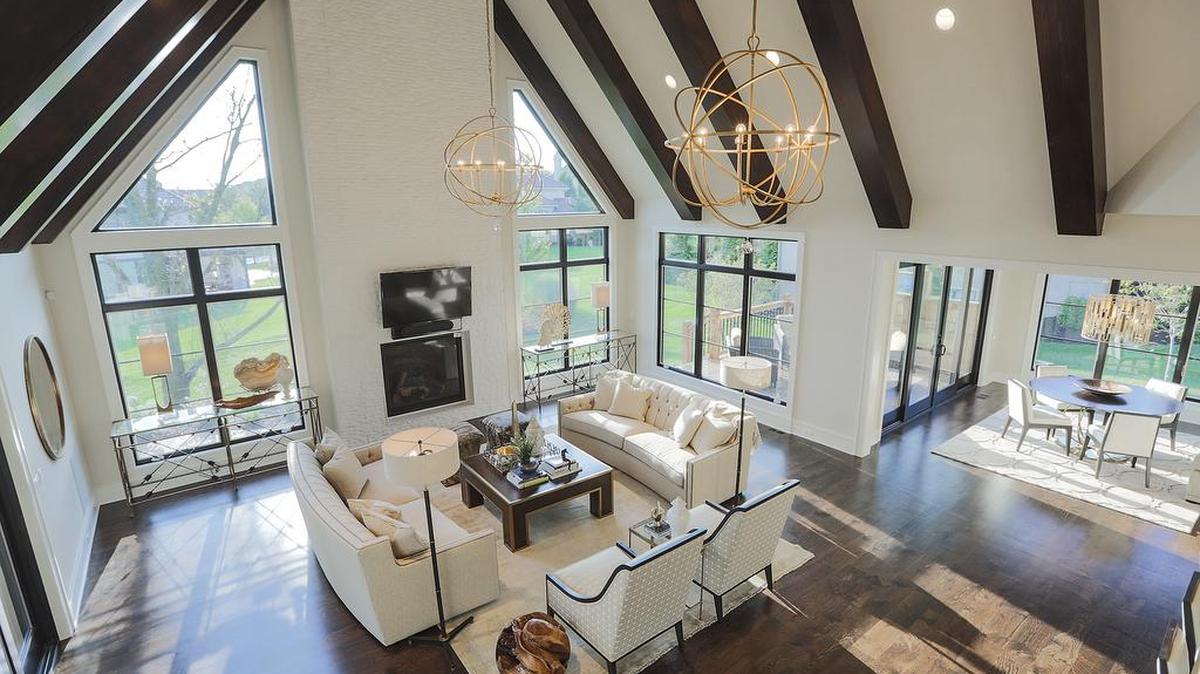 
This Artisan Home Tour entry by Lambie Custom Homes offers light and airy spaces created by the vaulted ceiling with wood beams and large windows.
