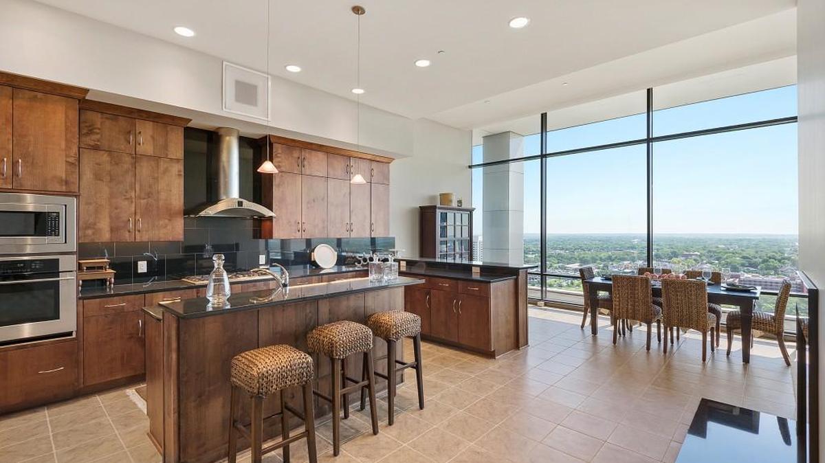 An open house at One Park Place, hosted by Team Mall, includes a penthouse level condo featuring a kitchen designed to cater to the needs of even the most discriminating chef. Stainless steel appliances, a large pantry, wrap-around peninsula and island complete the space. This two-bedroom, 2½-bathroom condo is listed at $885,000.