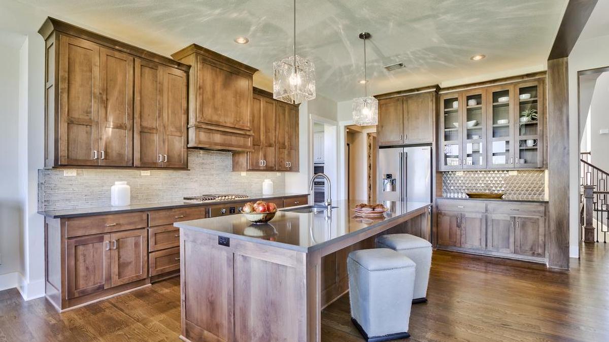 The two-story, five-bedroom artisan-style Hailey in the Rodrock Homes Summerwood community features a gourmet-inspired kitchen with plenty of storage and a large pantry and second kitchen located adjacent.
