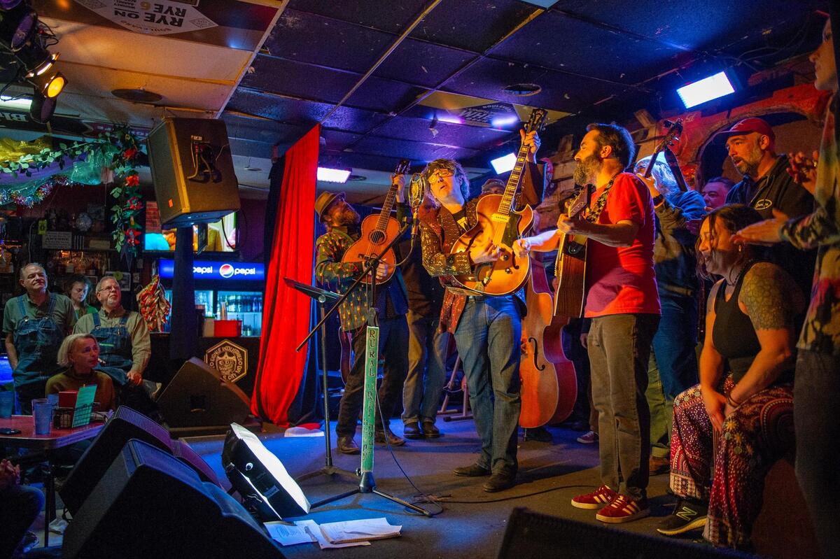Rural Grit performers singing “The Living Breathing Folk Song,” in which each performer contributed their own anti-stadium verse.