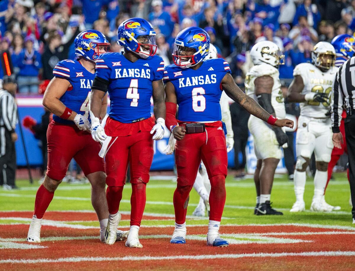Kansas Jayhawks running back Devin Neal (4) and quarterback Jalon Daniels (6) celebrate after Neal’s fourth touchdown against the Colorado Buffaloes in the second half at GEHA Field at Arrowhead Stadium on Saturday, Nov. 23, 2024, in Kansas City.