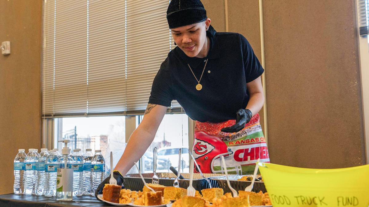 Avery Johnson, 16, gives samples of his macaroni and cheese with corn bread during The Village KC’s Young, Gifted and Black youth entrepreneur program at DeLaSalle Education Center.