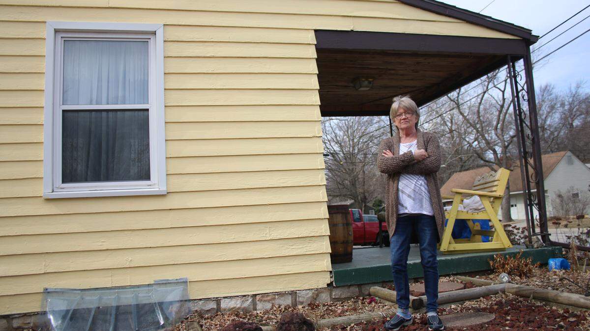 Roeland Park resident Joan Elliott stands in front of her house, which volunteers repainted last year as part of the Neighbors Helping Neighbors program.