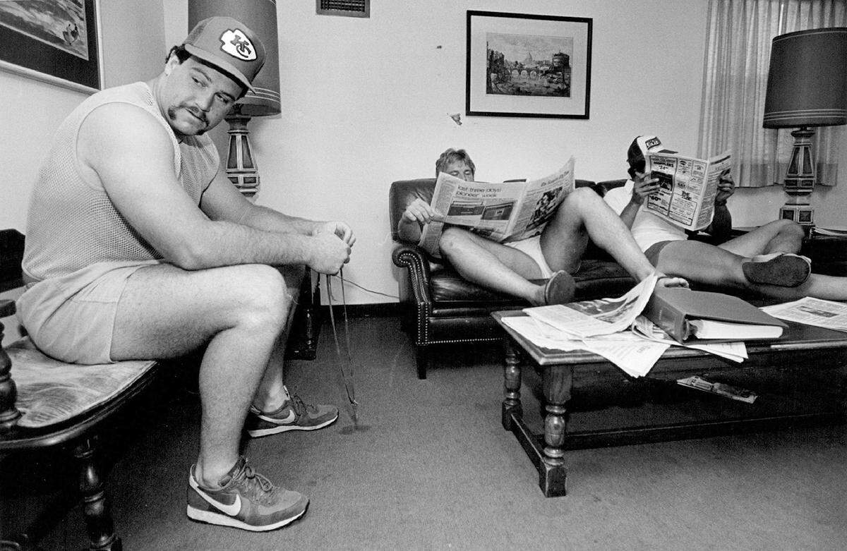 Offensive guard Chris O’Neil (left), linebacker Rob Purdham (left on couch) and tight end Greg Hogensen wait to be called into an office in 1982 with the news they were being cut by the Chiefs.