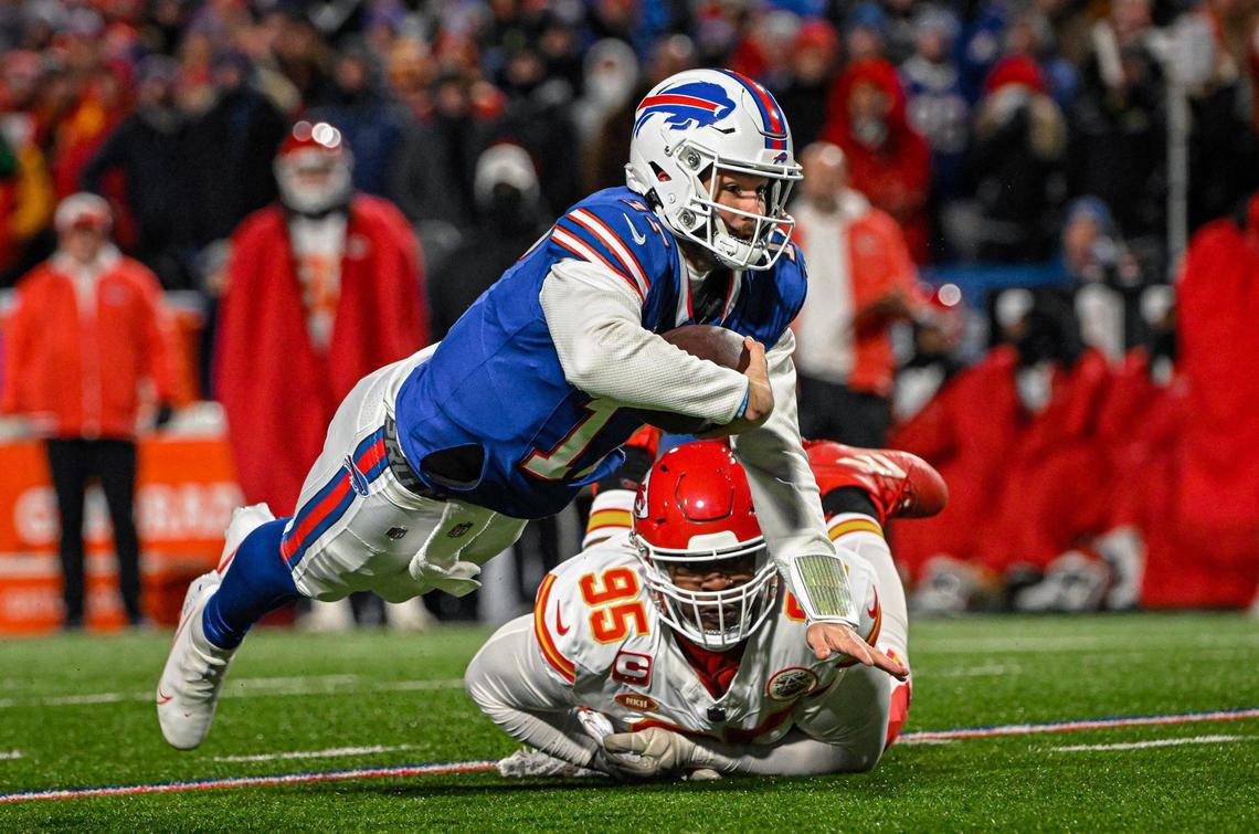 Kansas City Chiefs defensive tackle Chris Jones trips up Buffalo Bills quarterback Josh Allen (17) in the first half Sunday, Jan. 21, 2024, at Highmark Stadium in Orchard Park, New York.