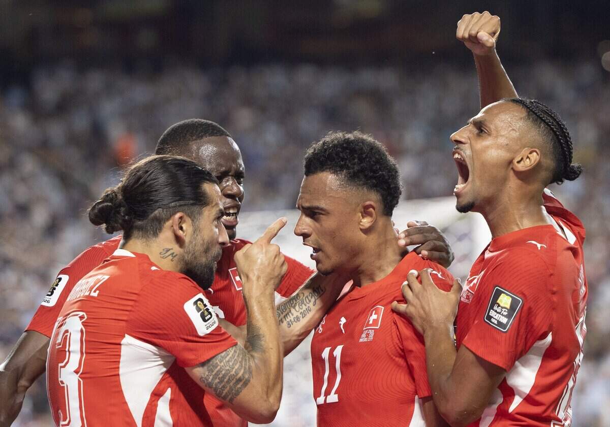 Switzerland players celebrates with Switzerland forward Dan Ndoye (11) after he scored a goal against Argentina during the FIFA World Cup quarterfinal match at Kansas City (Arrowhead) Stadium in Kansas City on Saturday, July 11, 2026.