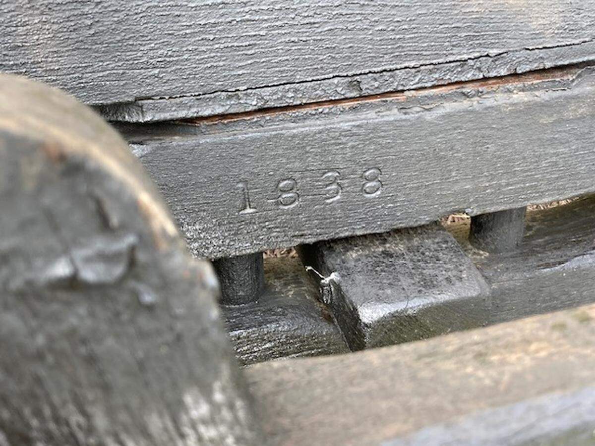 Long thought to be from the 1860s, a Conestoga-type wagon that stood for 61 years outside of the Old Westport Shopping Center was built in 1838, a stamp revealed on its axle shows.