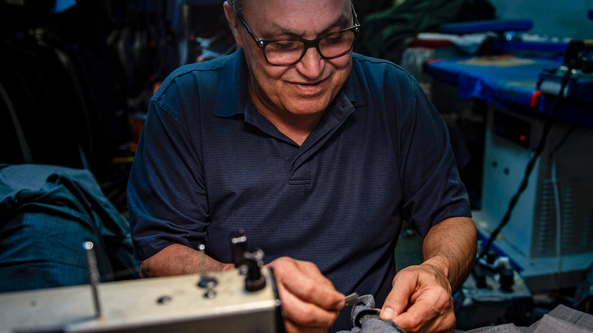 With wedding season in full bloom, Danny Assal of Dan’s Clothier & Tailor scrambles to finish work before the next phone call from a customer.