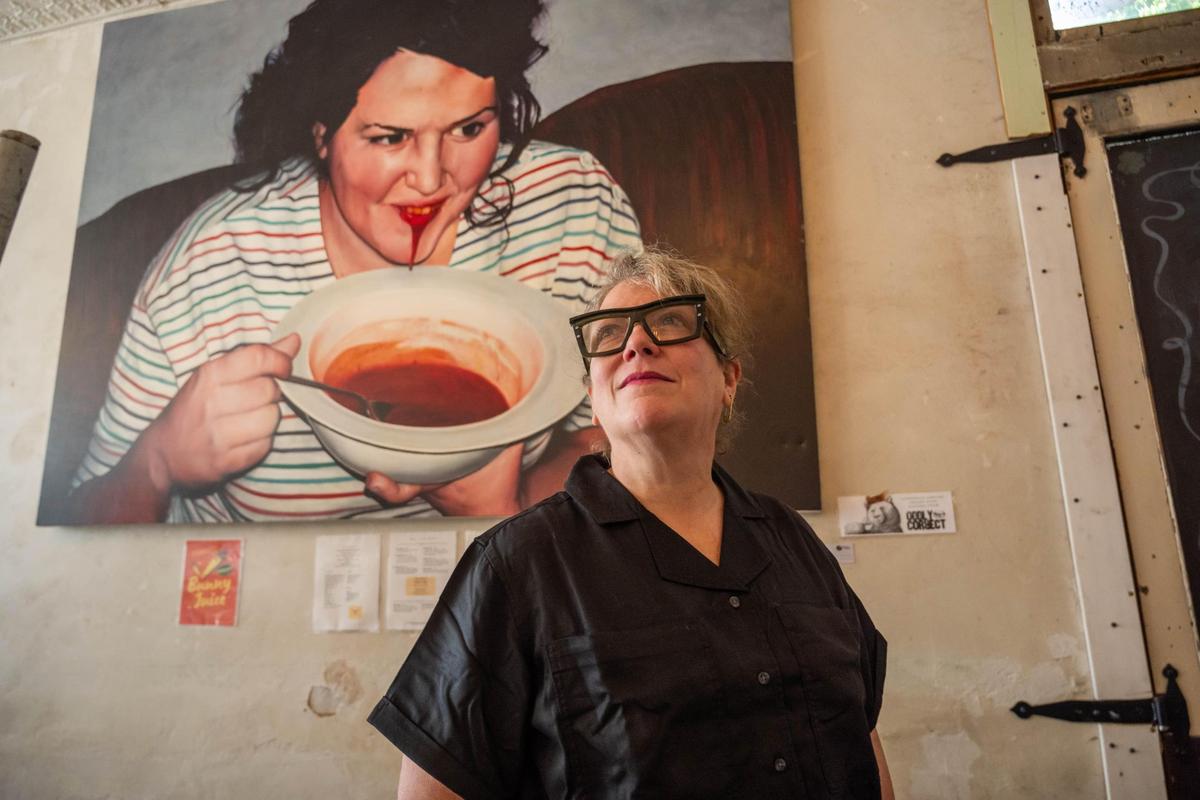 Beth Barden, the owner of Succotash in Kansas City, poses with one of her building’s eclectic decor pieces on June 16. The breakfast and brunch restaurant has been in business for over 20 years.