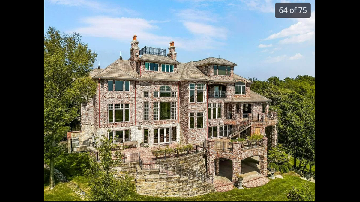The five-story house at 27596 W. Highland Circle in Olathe includes a fully-covered outdoor patio with an outdoor kitchen and fireplace. The back of the house, as seen above, features plenty of spots for you to lounge and view Shadow Lake.