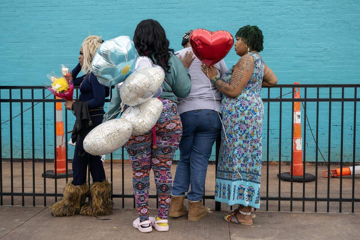 One day after a nightclub shooting left two women dead, family and friends gathered outside the club at 2801 Southwest Blvd. on Monday, Feb. 16, 2026, in Kansas City, to release memorial balloons for Eboni Silas and comfort one another. Authorities identified the victims as Eboni Silas, 29, and Tishauna Ballard, 23.