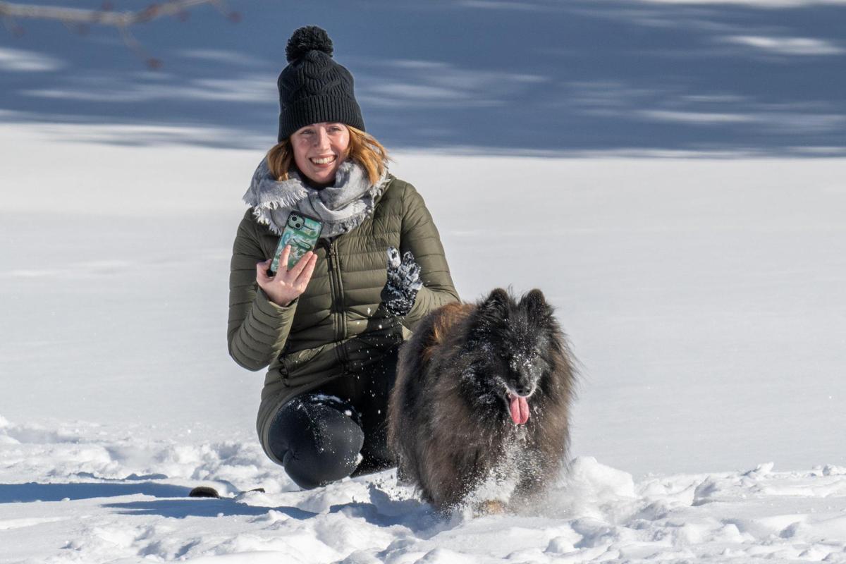 Alexandra Purvis-Smith and her dog, Zelda, play in the snow in Kansas City on Monday, Jan. 6, 2025.