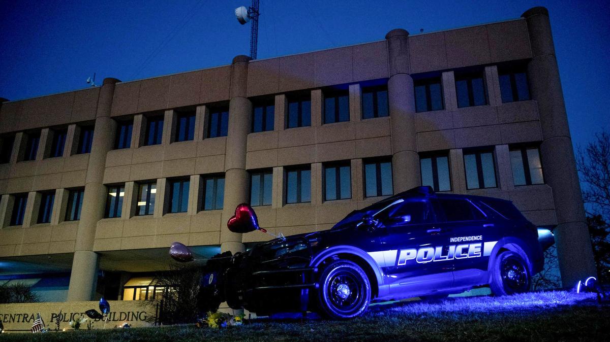 An Independence police car is lit with a blue light to honor Officer Cody Allen outside of the department’s headquarters on Friday, March 1, 2024, in Independence. Allen was shot and killed Thursday after shots were fired during an eviction. Drexel Max, a civil process server for the Jackson County Circuit Court, was as also shot and killed.